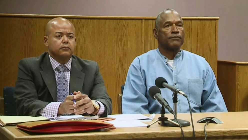 PHOTO: Former NFL football star O.J. Simpson appears with his attorney, Malcolm LaVergne, left, via video for his parole hearing at the Lovelock Correctional Center in Lovelock, Nev., on July 20, 2017.