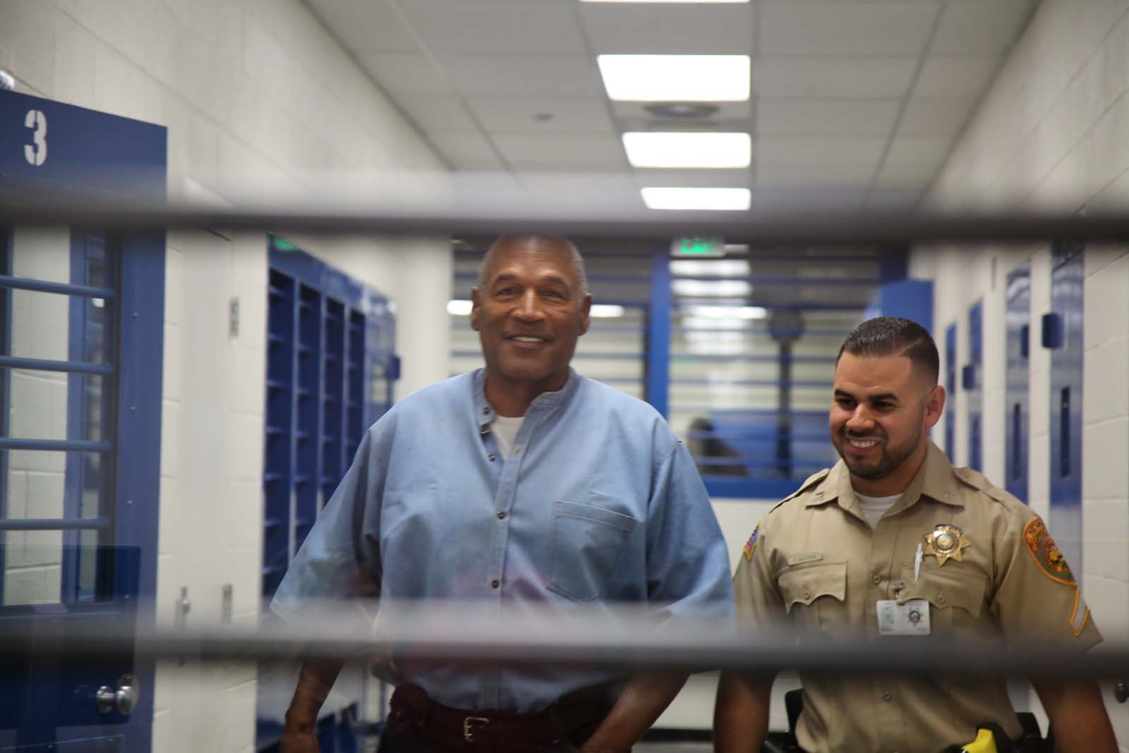 PHOTO: O.J. Simpson smiles as he approaches the parole hearing room to attend his hearing at the Lovelock Correctional Center in Lovelock, Nevada, July 20, 2017.