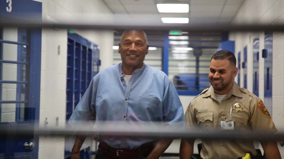O.J. Simpson smiles as he approaches the parole hearing room to attend his hearing at the Lovelock Correctional Center in Lovelock, Nevada, July 20, 2017.