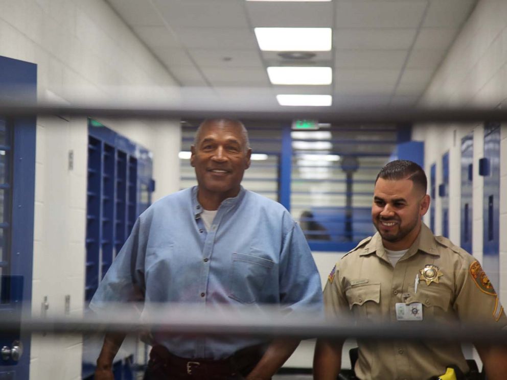 PHOTO: O.J. Simpson smiles as he approaches the parole hearing room to attend his hearing at the Lovelock Correctional Center in Lovelock, Nevada, July 20, 2017.