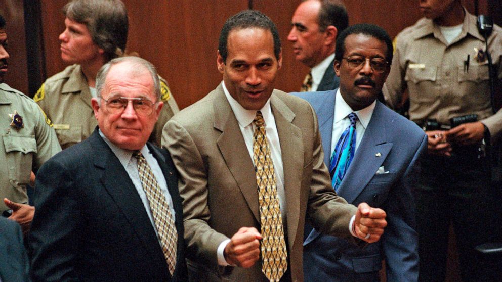 O.J. Simpson, center, reacts as he is found not guilty of murdering his ex-wife Nicole Brown Simpson and her friend Ron Goldman, with attorneys F. Lee Bailey, left, and Johnnie Cochran Jr., right, in Los Angeles Superior Court, Oct. 3, 1995.