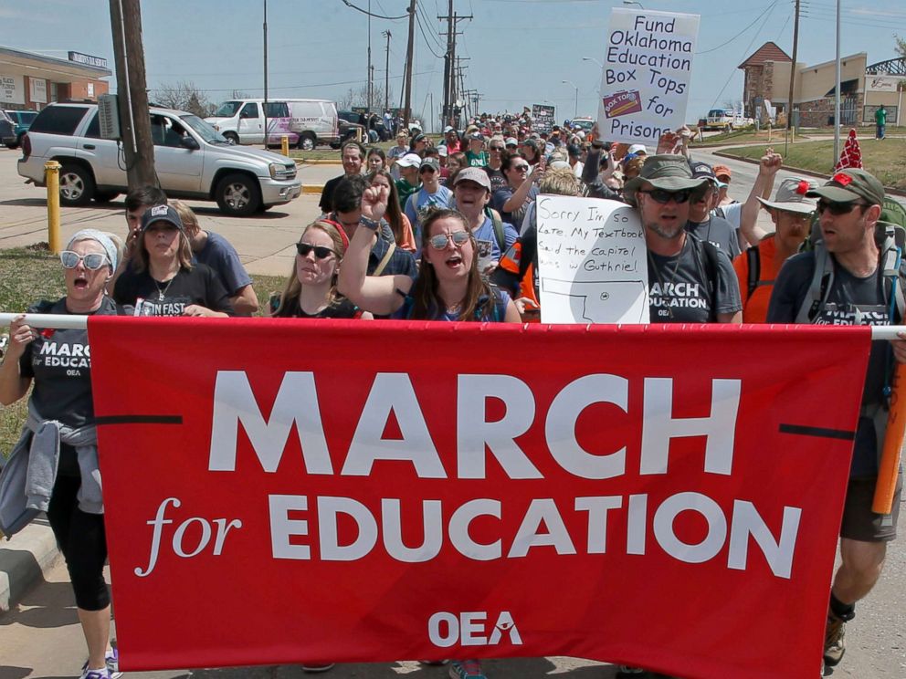 PHOTO: Demonstrators walk along NE 36th St. in the final leg of a 110 mile trip from Tulsa to the state Capitol, as protests continue over school funding, in Oklahoma City, April 10, 2018.