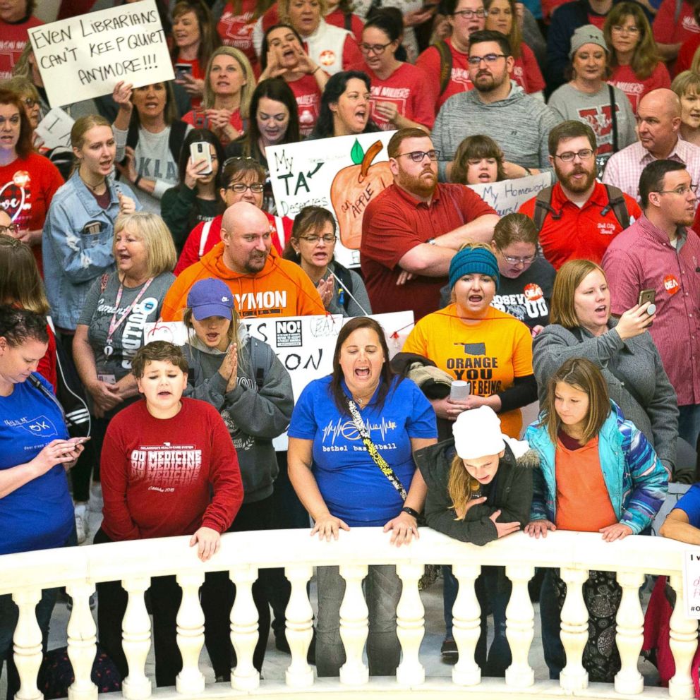 Hundreds of Oklahoma teachers, students, administrators and parents filled the Oklahoma state house rotunda to call for school funding and fairer wages.