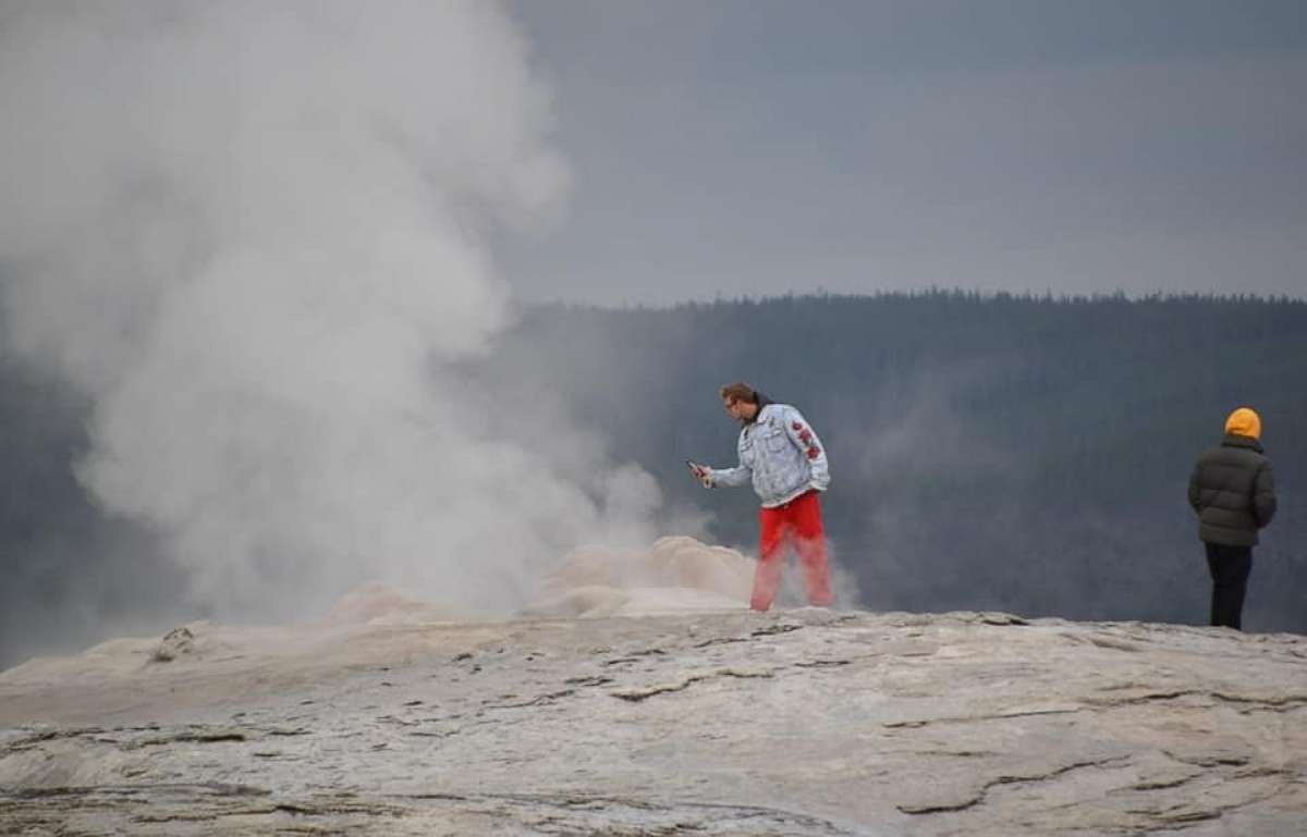 PHOTO: Two men face criminal charges for walking onto Old Faithful Geyser in Yellowstone National Park.