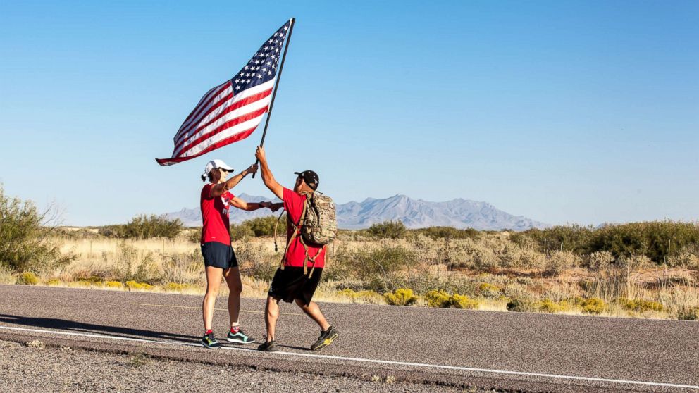 PHOTO: Two runners perform the handoff moment of the American flag near Columbus, N.M., Oct. 11, 2017. 