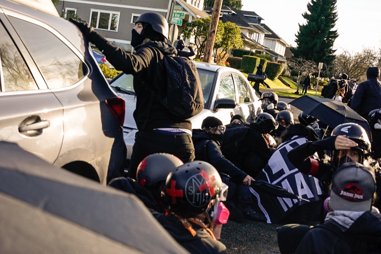 PHOTO: Counterprotesters take cover after a shooter opened fire during confrontations with Donald Trump supporters, including Proud Boys, during a rally on Dec. 12, 2020, in Olympia, Wash.