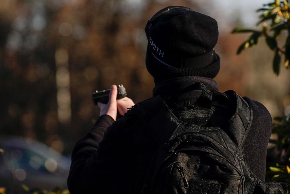 PHOTO: A counterprotester takes aim after a far-right demonstrator opened fire during political clashes on Dec. 12, 2020, in Olympia, Wash.