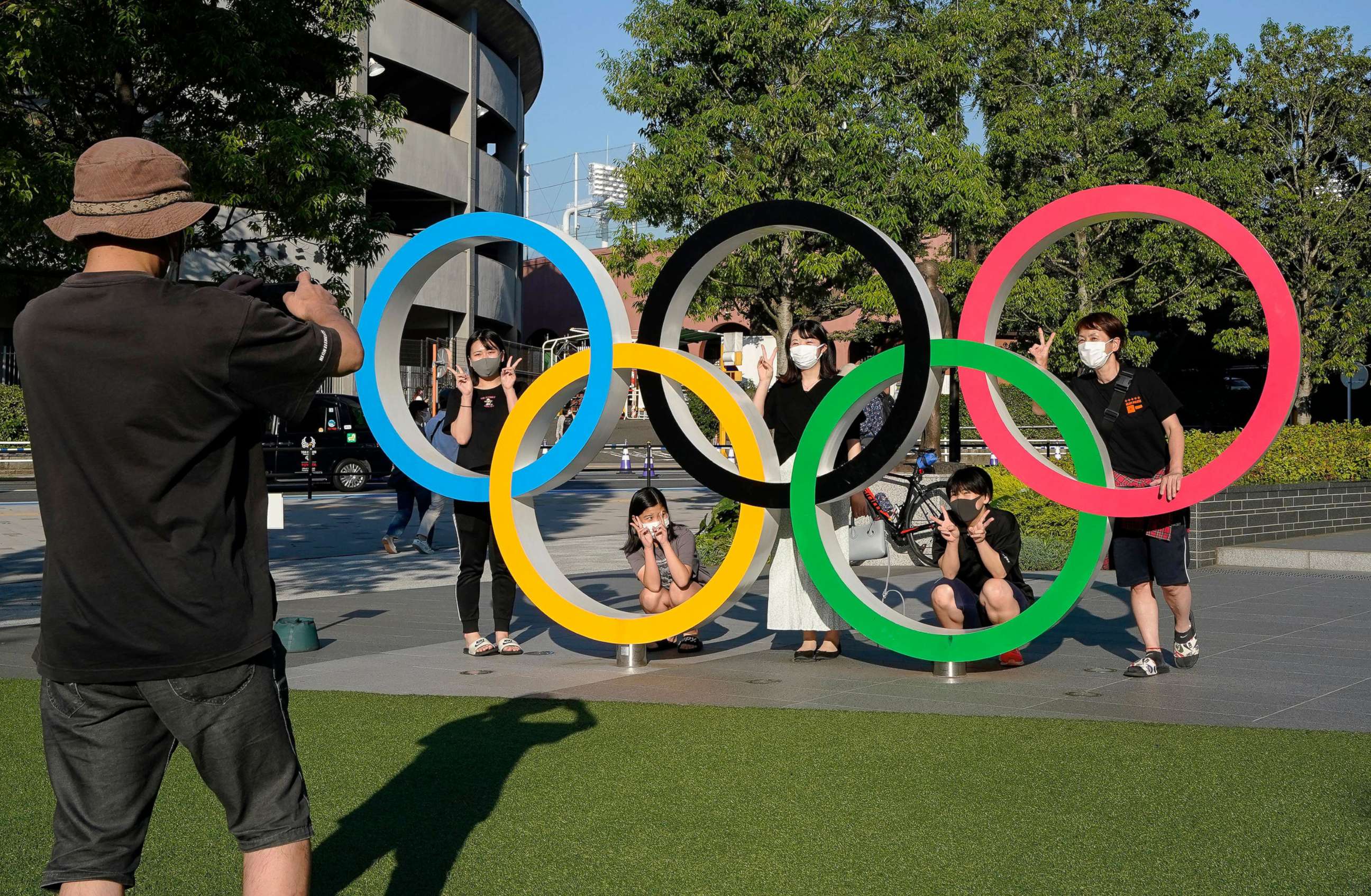 PHOTO: Visitors take commemorating photos with an Olympic Rings monument at the Japan Olympic Committee (JOC) near the New National Stadium, an Olympic Stadium for the Tokyo 2020, in Tokyo, Japan, May 23, 2021.