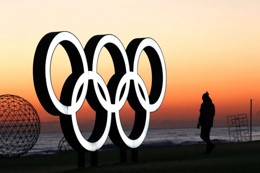 PHOTO: A tourist waits for the sun rise next to the Olympic rings installation near venues of the PyeongChang Winter Olympic Games 2018, in Gangneung, South Korea, Jan. 30, 2018. 
