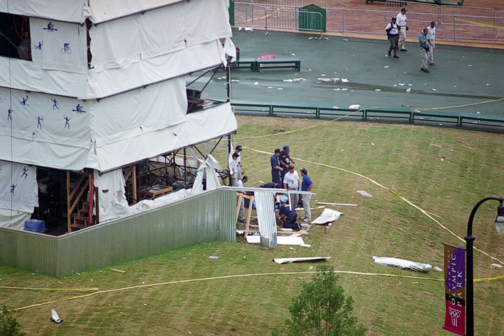 PHOTO: Local police officers, FBI agents, and ATF agents investigate the bomb site area in Centennial Park during the 1996 Atlanta Olympic Games, July 27, 1996.