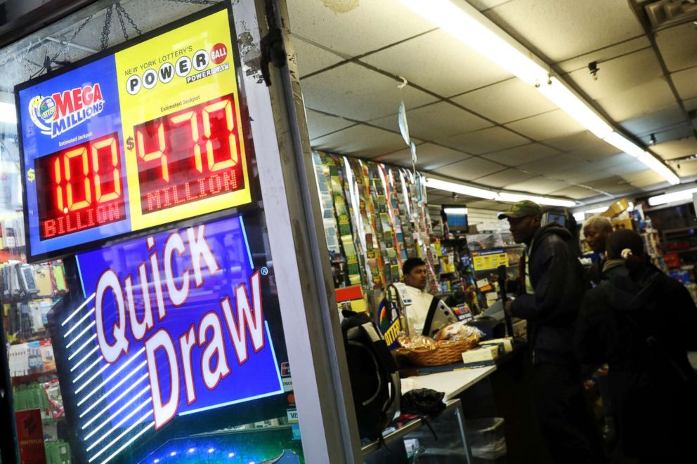 PHOTO: Signs display the jackpots for Mega Millions and Powerball lottery drawings as customers line up at a store in midtown Manhattan in New York, Oct. 19, 2018.