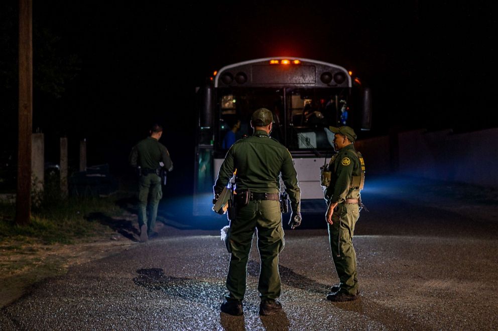 PHOTO: Border Patrol officers speak together after processing and loading migrants onto a bus, May 5, 2022, in Roma, Texas.