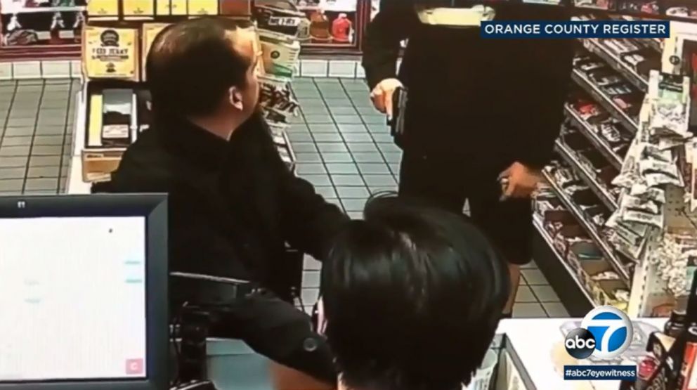 PHOTO: Surveillance video shows an off-duty Buena Park police officer pointing his gun at a man he thought stole Mentos at a gas station. The man had actually just purchased them.