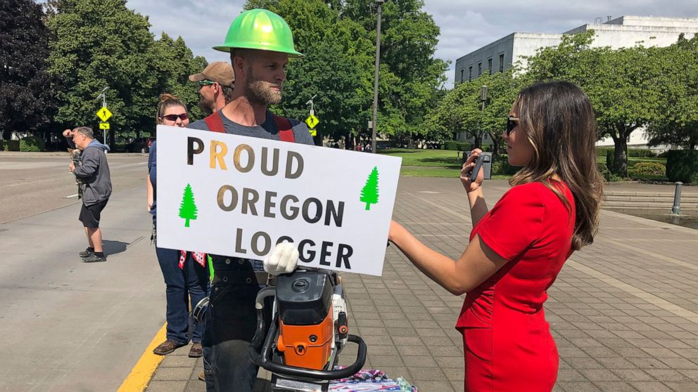 PHOTO: A TV reporter interviews self-employed logger Bridger Hasbrouck, of Dallas, Ore., outside the Oregon State House in Salem, Ore., on Thursday, June 20, 2019, the day the Senate was scheduled to take up a bill that would curb carbon emissions.