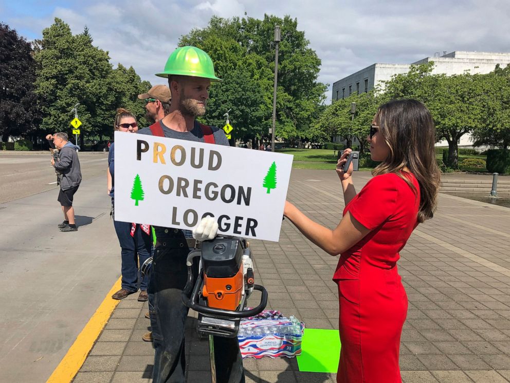 PHOTO: A TV reporter interviews self-employed logger Bridger Hasbrouck, of Dallas, Ore., outside the Oregon State House in Salem, Ore., on Thursday, June 20, 2019, the day the Senate was scheduled to take up a bill that would curb carbon emissions.