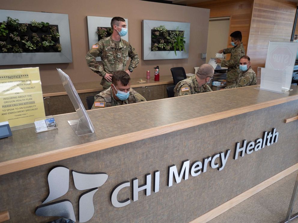 PHOTO: 1st Battalion, 186th Infantry Regiment, Oregon National Guard soldiers staff the front desk and screen patients at Mercy Medical Center, in Roseburg, Ore., Aug. 21, 2021.