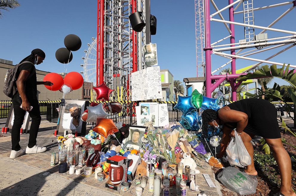 PHOTO: Family members and friends of Tyre Sampson leave flowers and other items at a vigil in front of the Orlando Free Fall drop tower in ICON Park in Orlando, Fla., March 28, 2022. Sampson, 14, was killed when he fell from the ride last week. 