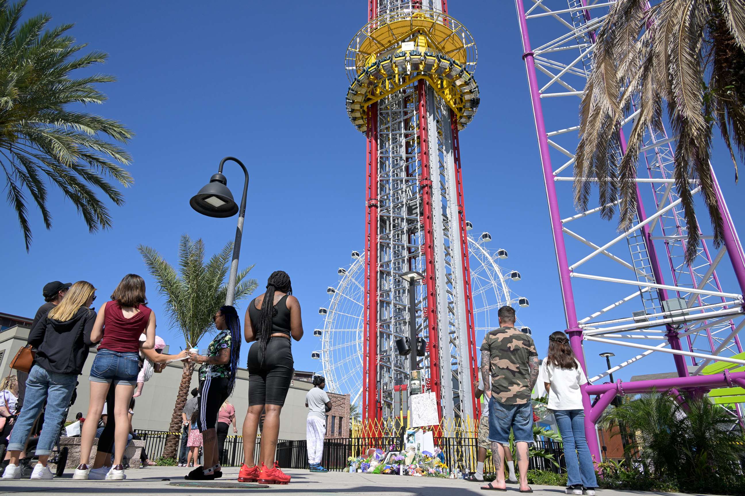 PHOTO: People visit a makeshift memorial for Tyre Sampson outside the Orlando Free Fall ride at the ICON Park entertainment complex, on March 27, 2022, in Orlando, Fla.