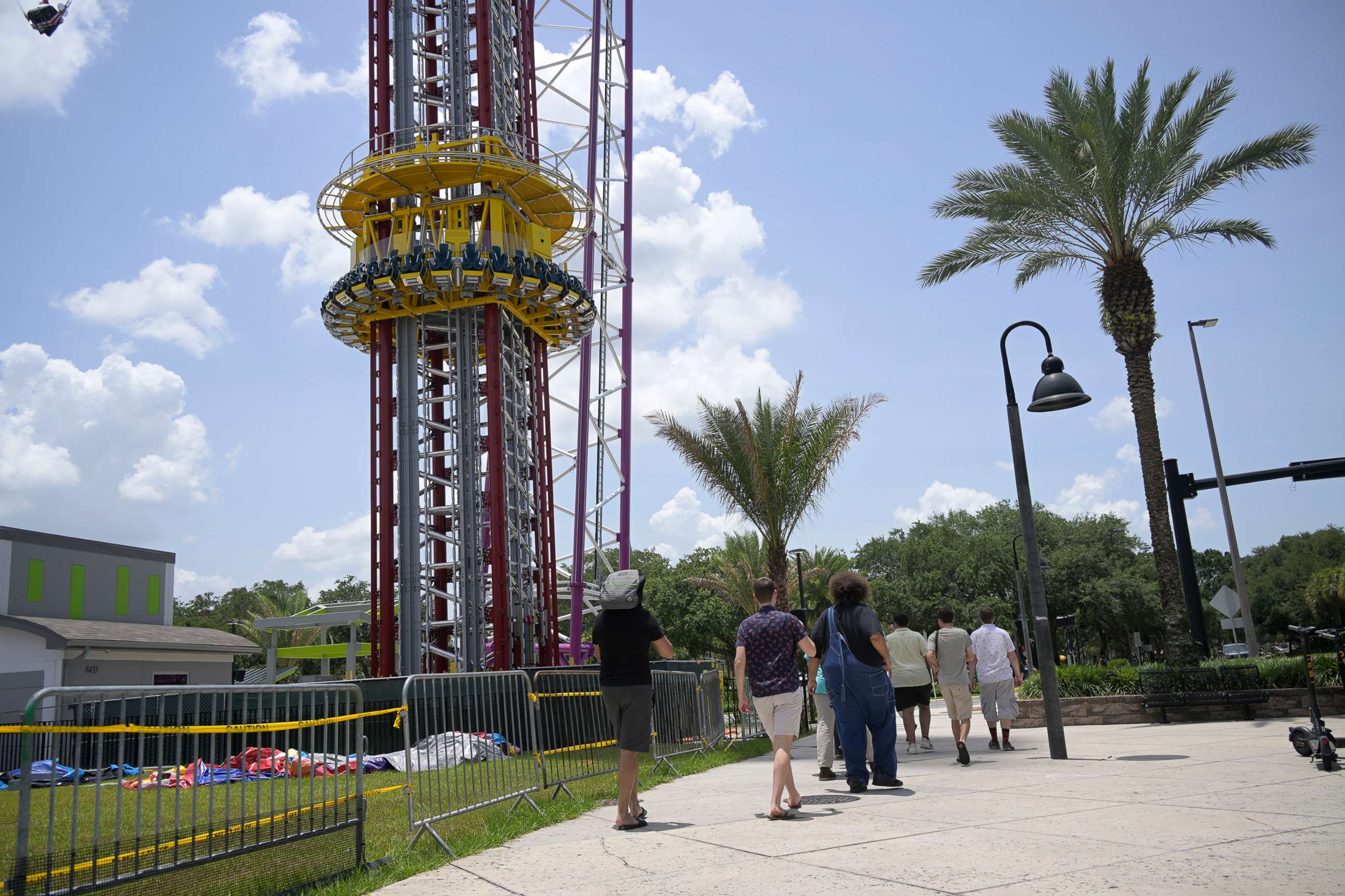 PHOTO: People walk past the Orlando Free Fall ride at the ICON Park entertainment complex, where Tyre Sampson fell to his death while on the ride in Orlando, Fla. June 15, 2022.