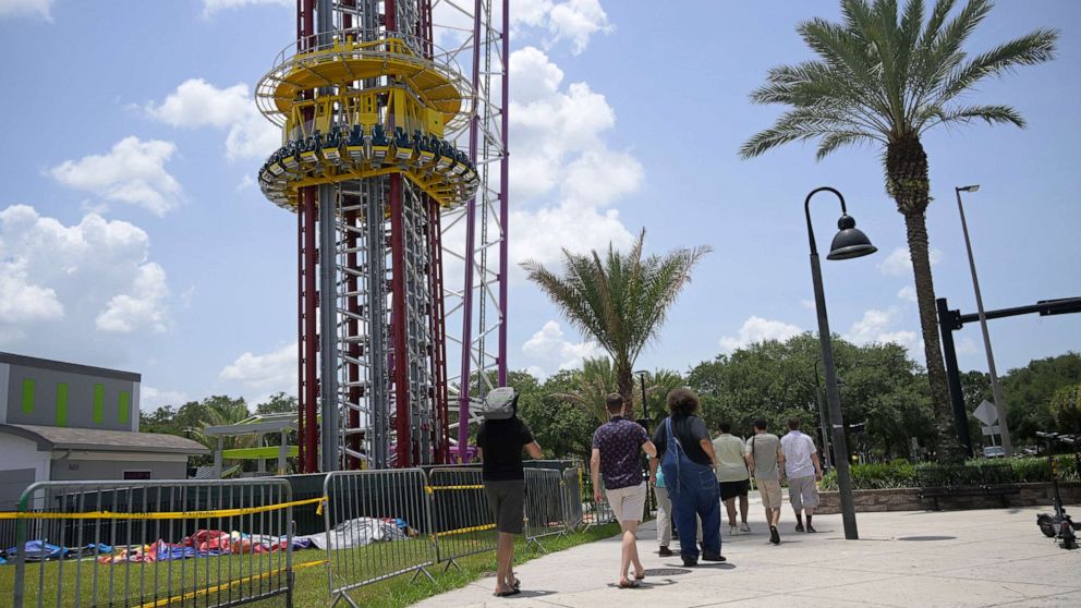 PHOTO: People walk past the Orlando Free Fall ride at the ICON Park entertainment complex, where Tyre Sampson fell to his death while on the ride in Orlando, Fla. June 15, 2022.