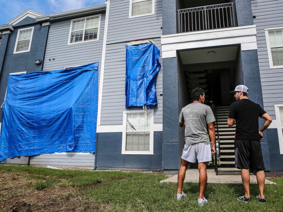 PHOTO: Residents at Westbrook Apartments get a first look at their building where a gunman held four children hostage before taking their life and his own, June 12, 2018, in Orlando, Fla.