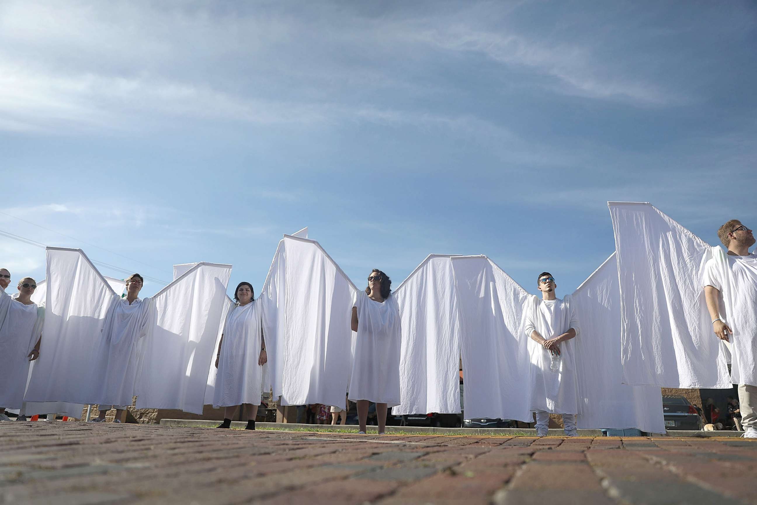 PHOTO: People dressed as angels stand in front of the memorial set up for the shooting victims at Pulse nightclub where the shootings took place two years ago, June 12, 2018, in Orlando, Fla.