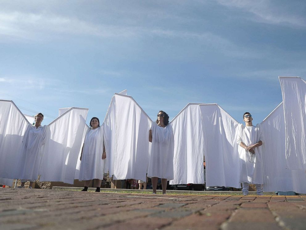 PHOTO: People dressed as angels stand in front of the memorial set up for the shooting victims at Pulse nightclub where the shootings took place two years ago, June 12, 2018, in Orlando, Fla.