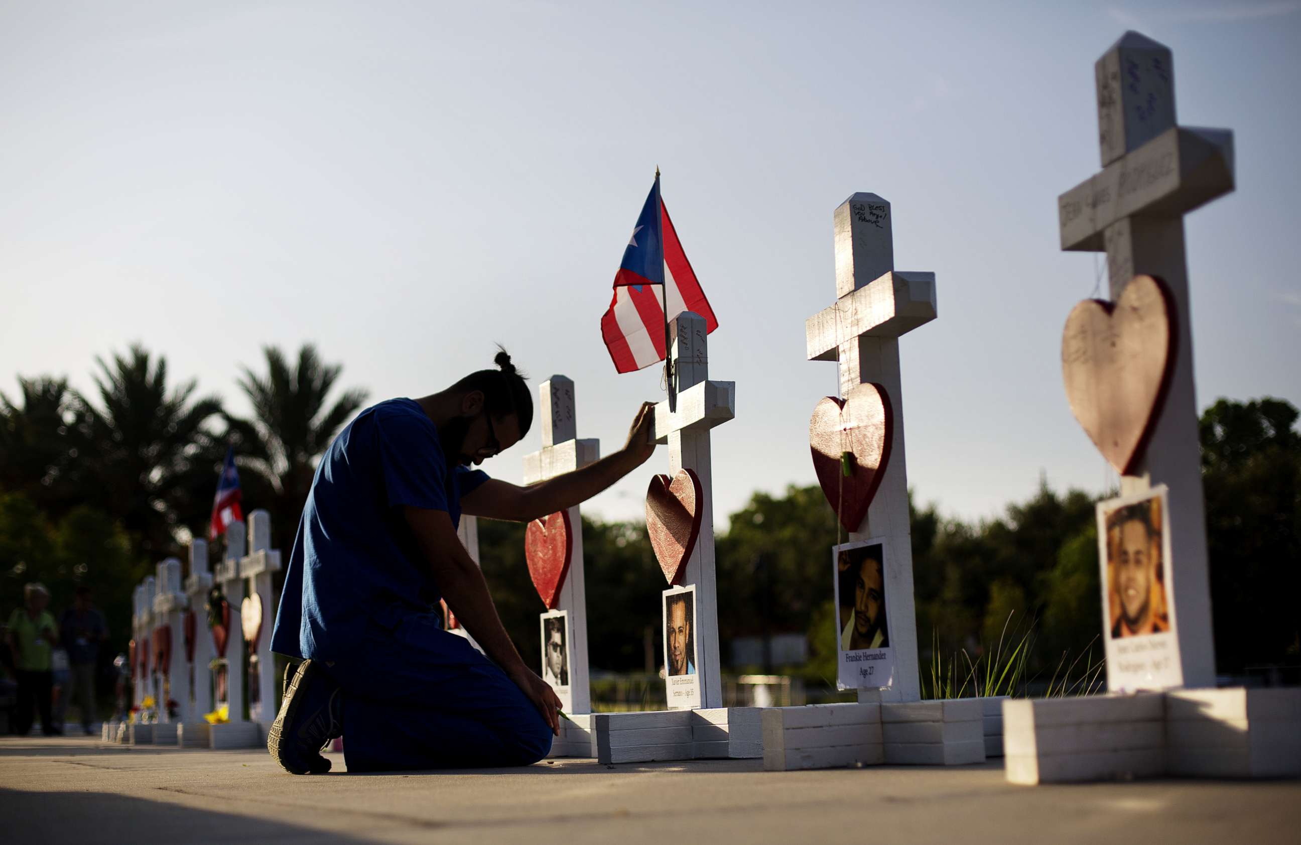PHOTO: Ernesto Vergne prays at a cross honoring his friend Xavier Emmanuel Serrano Rosado and the other victims at a memorial to those killed in the Pulse nightclub mass shooting a few blocks from the club early Friday, June 17, 2016, in Orlando, Fla.