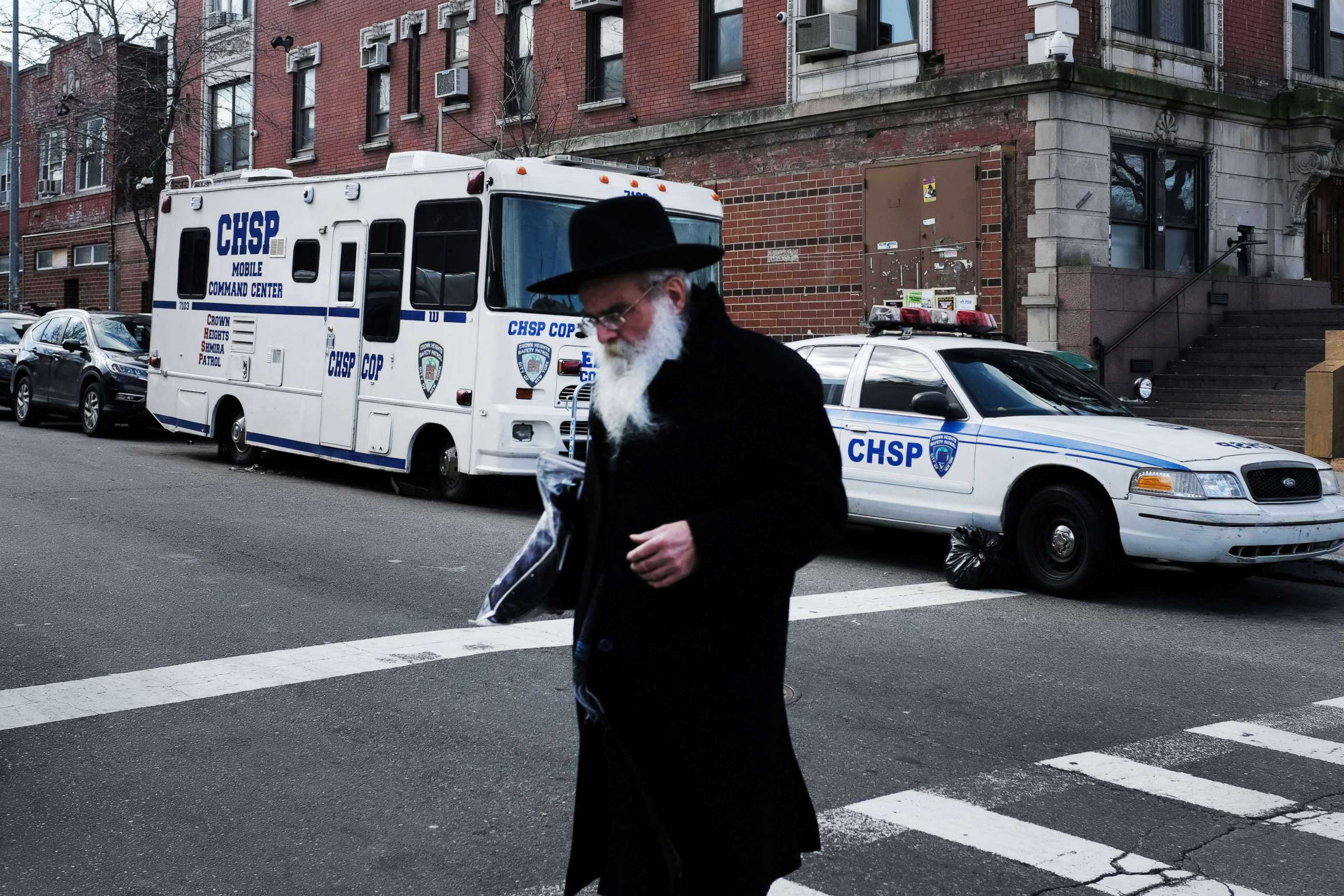 PHOTO: An Orthodox Jewish man walks past a security vehicle in the neighborhood of Crown Heights, Feb. 25, 2019, in New York City.