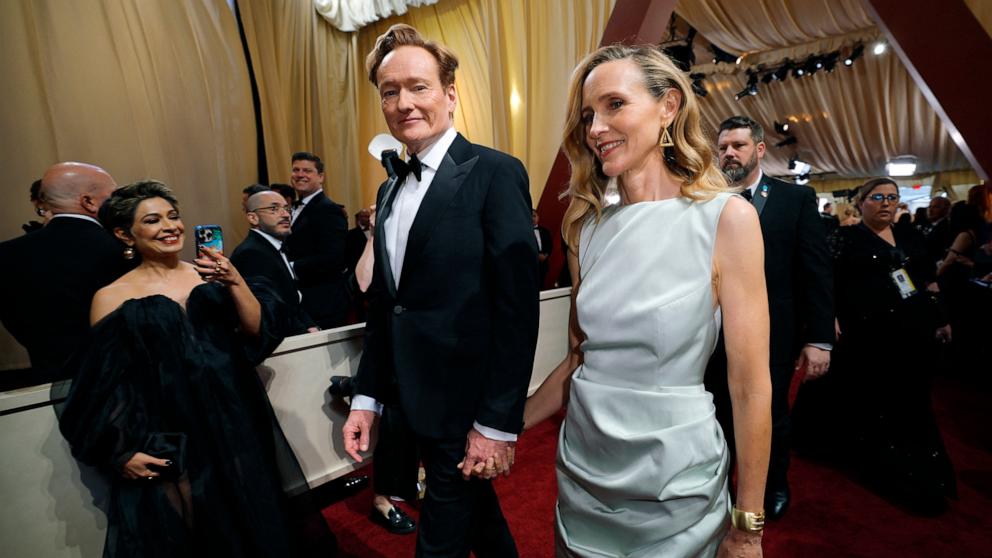 PHOTO: Conan O'Brien and Liza Powel O'Brien walk on the red carpet during the Oscars arrivals at the 97th Academy Awards in Los Angeles, Mar. 2, 2025. 