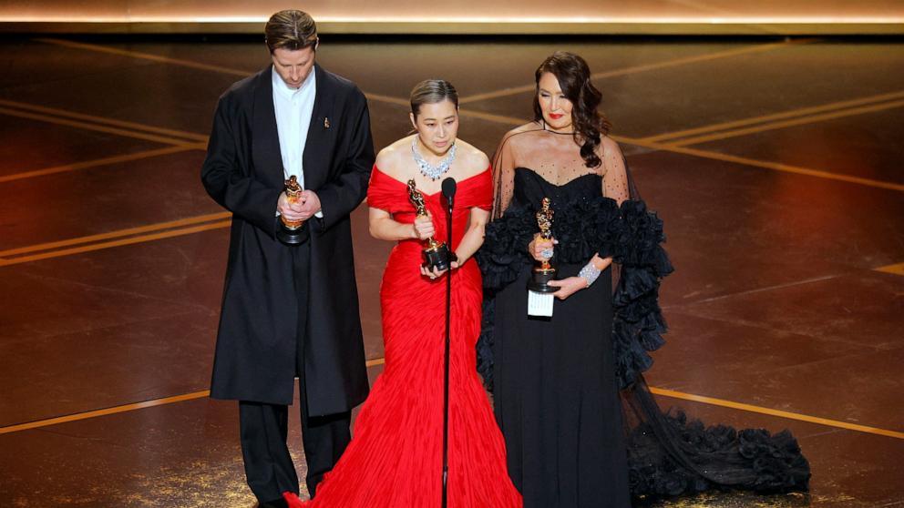 PHOTO: Maggie Kang, Chris Appelhans and Michelle L.M. Wong win the Oscar for Best Animated Feature Film for "KPop Demon Hunters" at the 98th Academy Awards, March 15, 2026 in Hollywood, Calif.