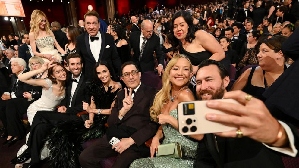 PHOTO: Danny Fujikawa takes a selfie with Kate Hudson, Demi Moore, Emma Stone and Dave McCary at the 98th Academy Awards, March 15, 2026 in Hollywood, Calif.