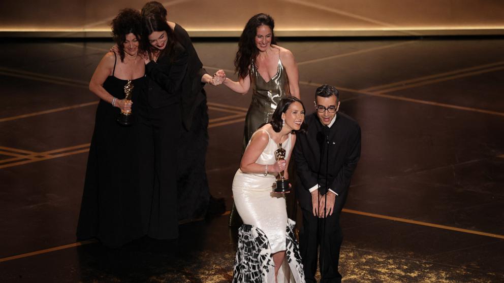 PHOTO: Natalie Musteata and Alexandre Singh accept the Oscar for Best Live Action Short Film for "Two People Exchanging Saliva" at the 98th Academy Awards, March 15, 2026 in Hollywood, Calif.