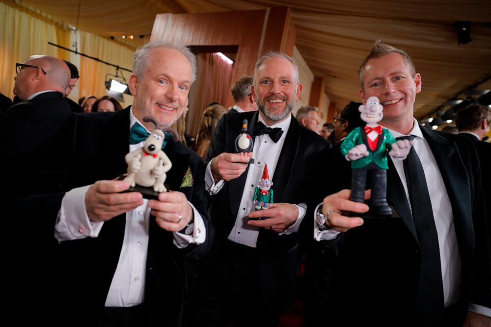 PHOTO: The creators of Wallace and Gromit Nick Park, Richard Beek, and Merlin Crossingham pose with their characters on the red carpet during the Oscars arrivals at the 97th Academy Awards in Los Angeles, Mar. 2, 2025. 