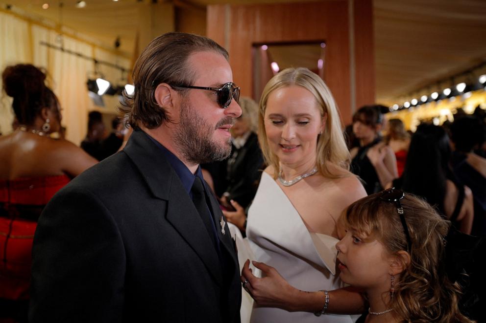 PHOTO: Brady Corbet, Mona Fastvold and their daughter Ada walk the red carpet during the Oscars arrivals at the 97th Academy Awards in Los Angeles, Mar. 2, 2025. 