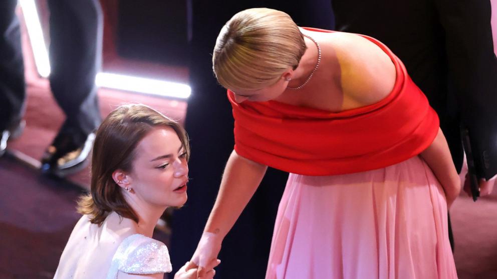 PHOTO: Emma Stone and Jessie Buckley talk at the 98th Academy Awards, March 15, 2026 in Hollywood, Calif.
