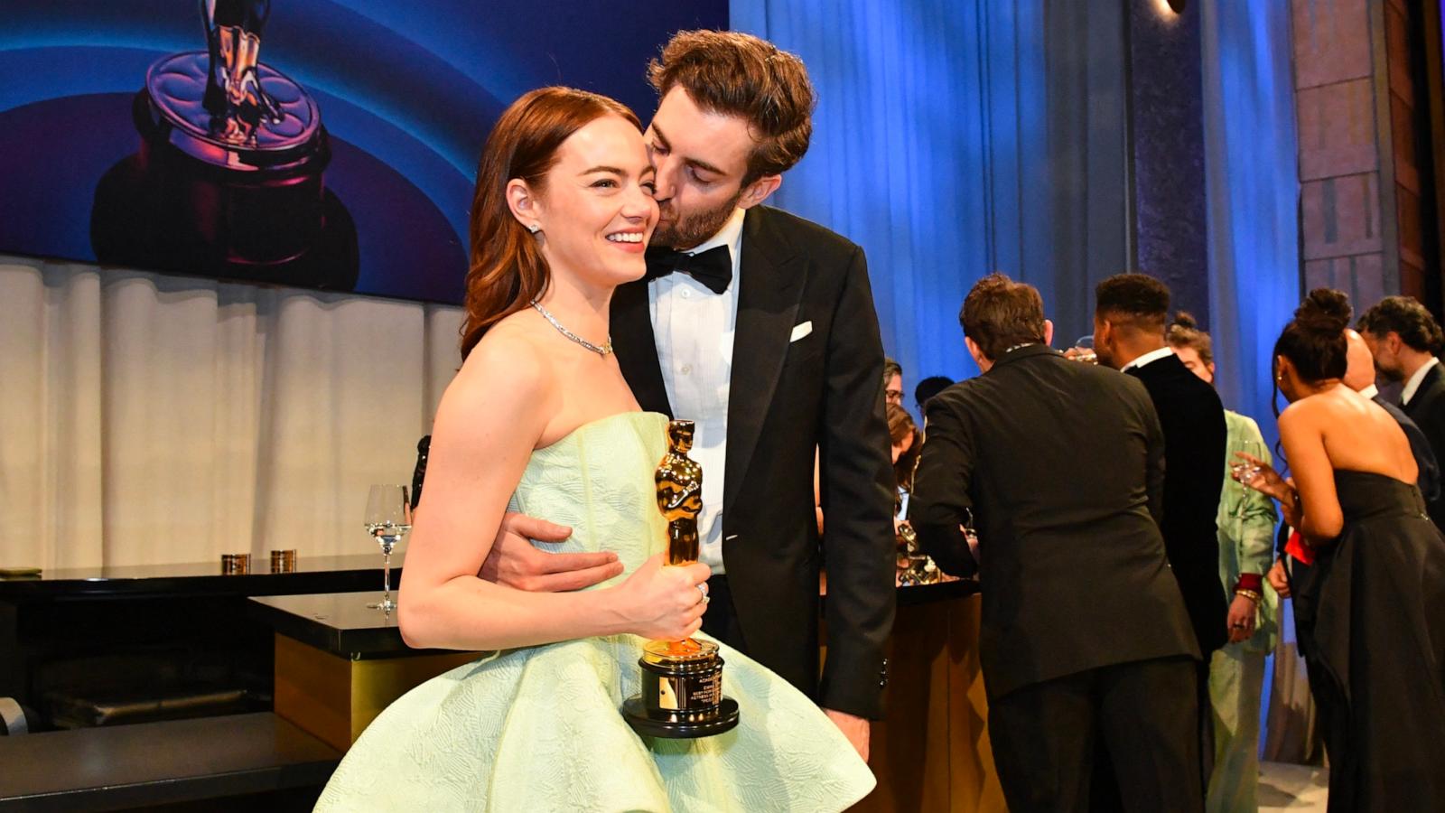 PHOTO: Emma Stone gets a kiss from husband Dave McCary as she holds her Oscar for Best Actress in a Leading Role while attending the 96th Annual Academy Awards Governors Ball, in Hollywood, Mar. 10, 2024.