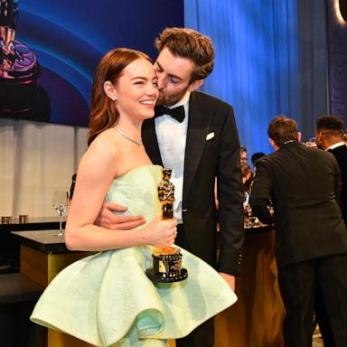 PHOTO: Emma Stone gets a kiss from husband Dave McCary as she holds her Oscar for Best Actress in a Leading Role while attending the 96th Annual Academy Awards Governors Ball, in Hollywood, Mar. 10, 2024.