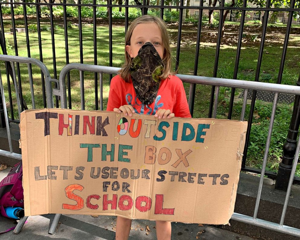 PHOTO: Fourth grader Conor Landauer holds a sign outside City Hall at a rally to demand street closures and park permits for New York City schools, Aug. 20, 2020.