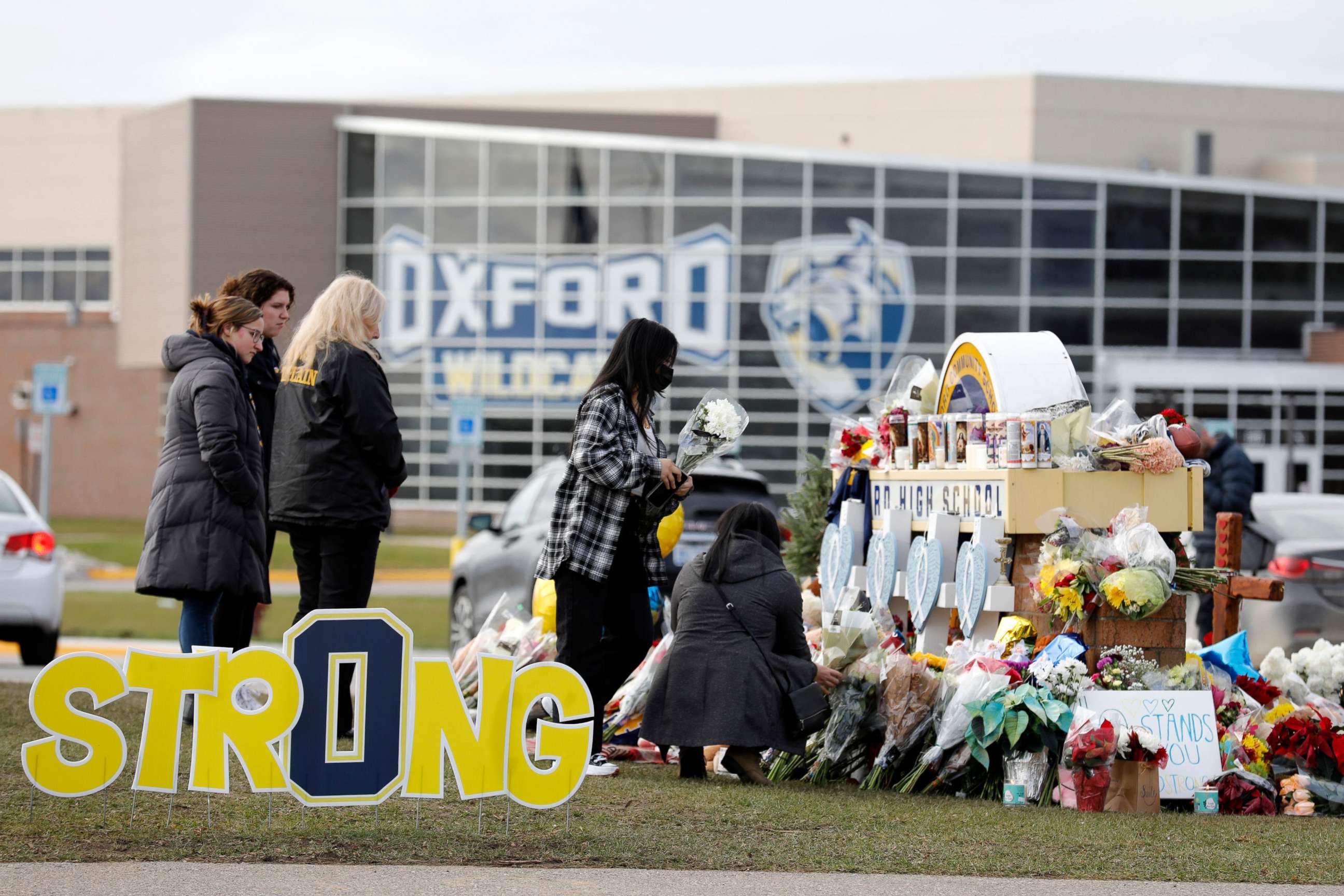 PHOTO: People gather at the memorial for the dead and wounded outside of Oxford High School in Oxford, Michigan, Dec. 3, 2021.