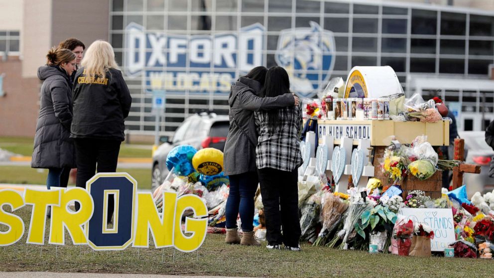 PHOTO: People gather at the memorial for the dead and injured outside Oxford High School in Oxford, Michigan, December 3, 2021.