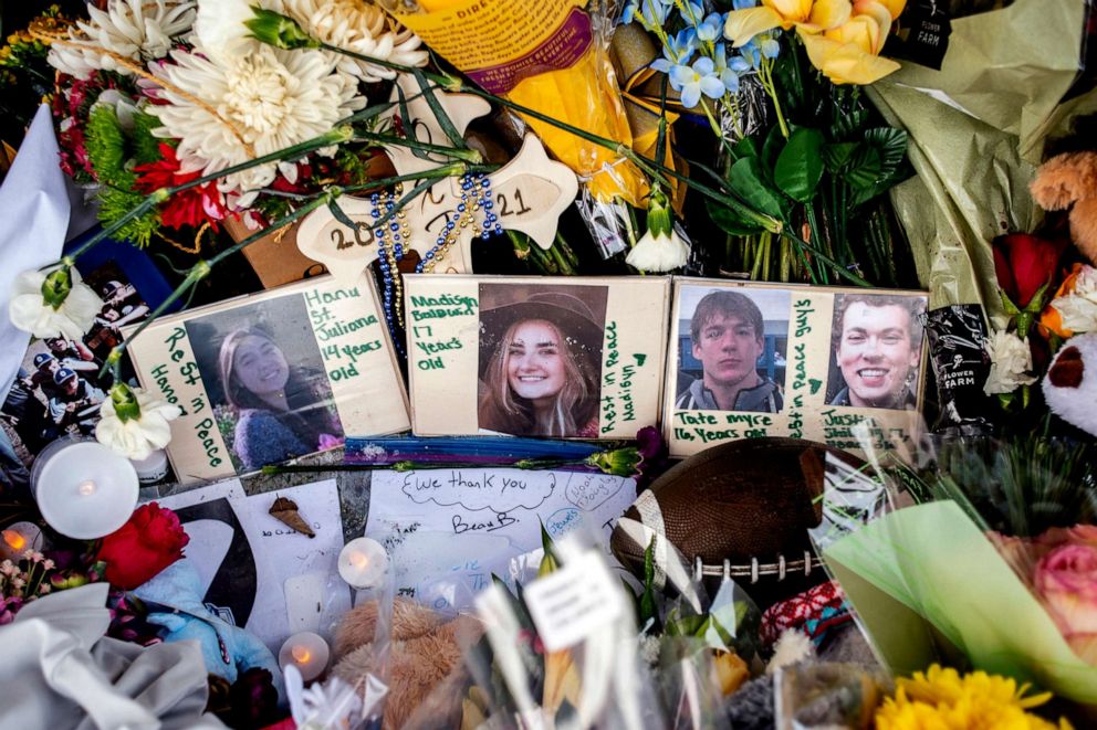 PHOTO: Photographs of the four students killed in the shooting, sit among bouquets of flowers, teddy bears and other personal items at the makeshift memorial site outside Oxford High School in Oxford, Mich., Dec. 7, 2021.