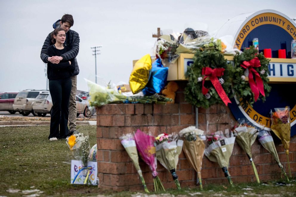 PHOTO: People mourn near a growing memorial outside Oxford High School, a day after a deadly school shooting, in Oxford, Mich., Dec. 1, 2021.