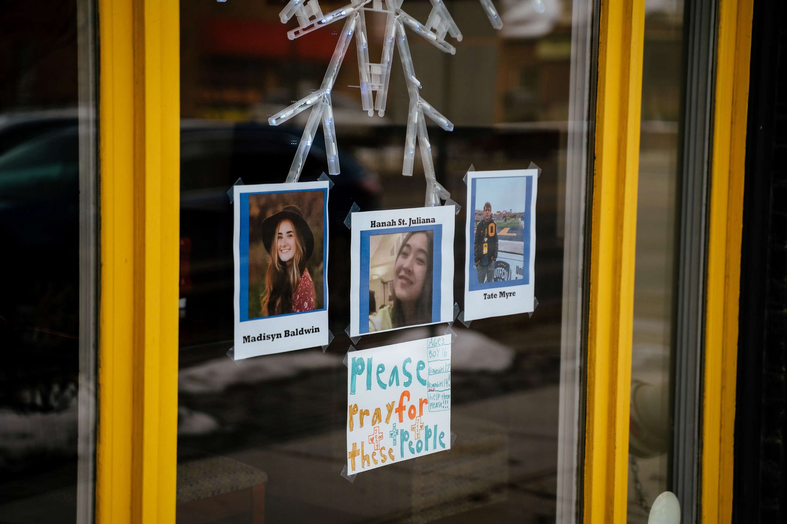 PHOTO: Photos of the Oxford High School students who were killed Nov. 30 are taped to a window of a business in Oxford, Mich., on Dec. 1, 2021. A fourth student died on Wednesday morning.