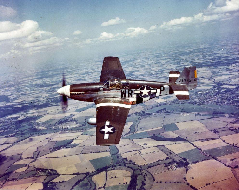 PHOTO: Aerial view of a P-51M Mustang fighter plane (from the US Air Force's 8th Air Force) in flight over England, 1940s.