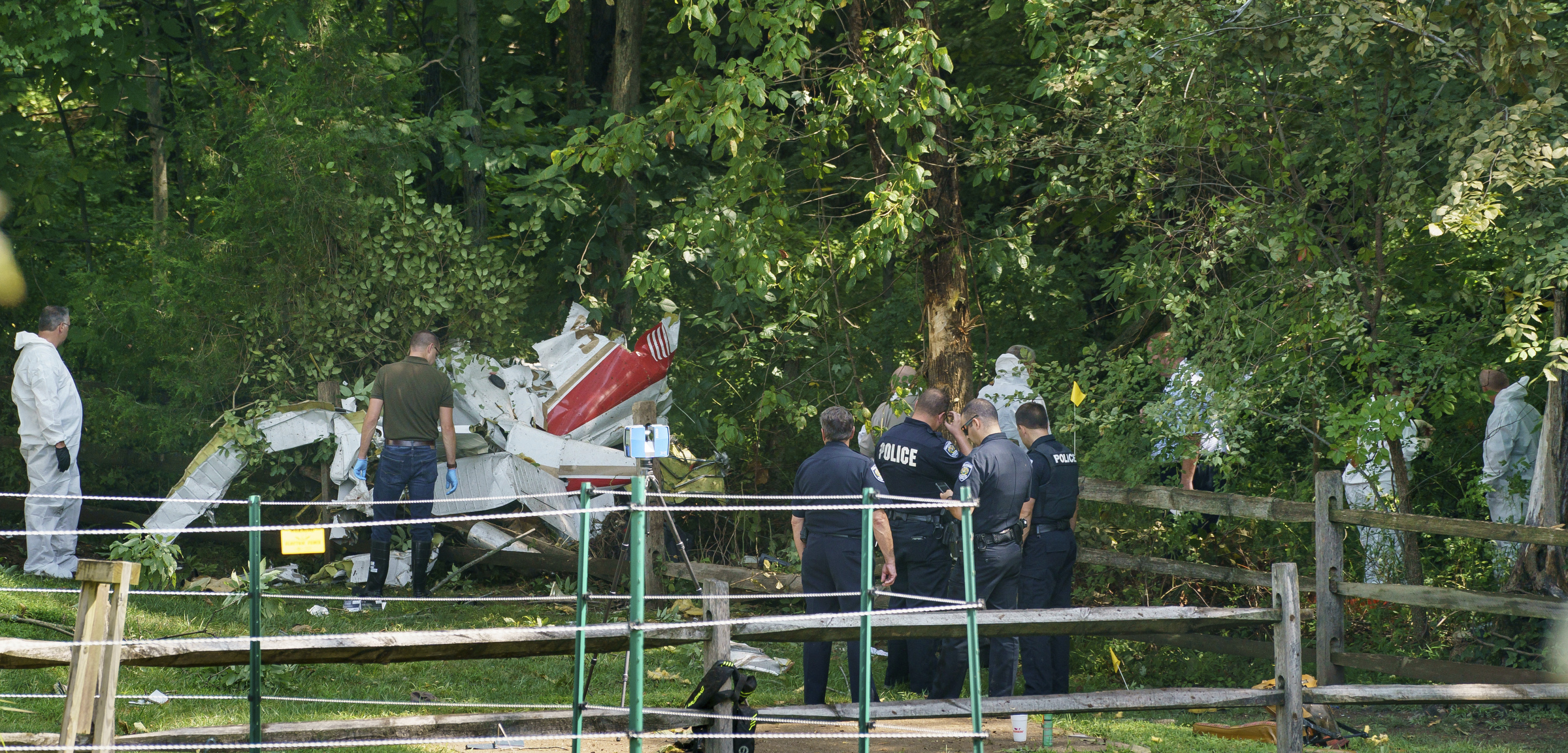 PHOTO: Officials investigate the scene where a small aircraft crashed in a residential neighborhood in Upper Moreland, Pa., Aug. 8, 2019.
