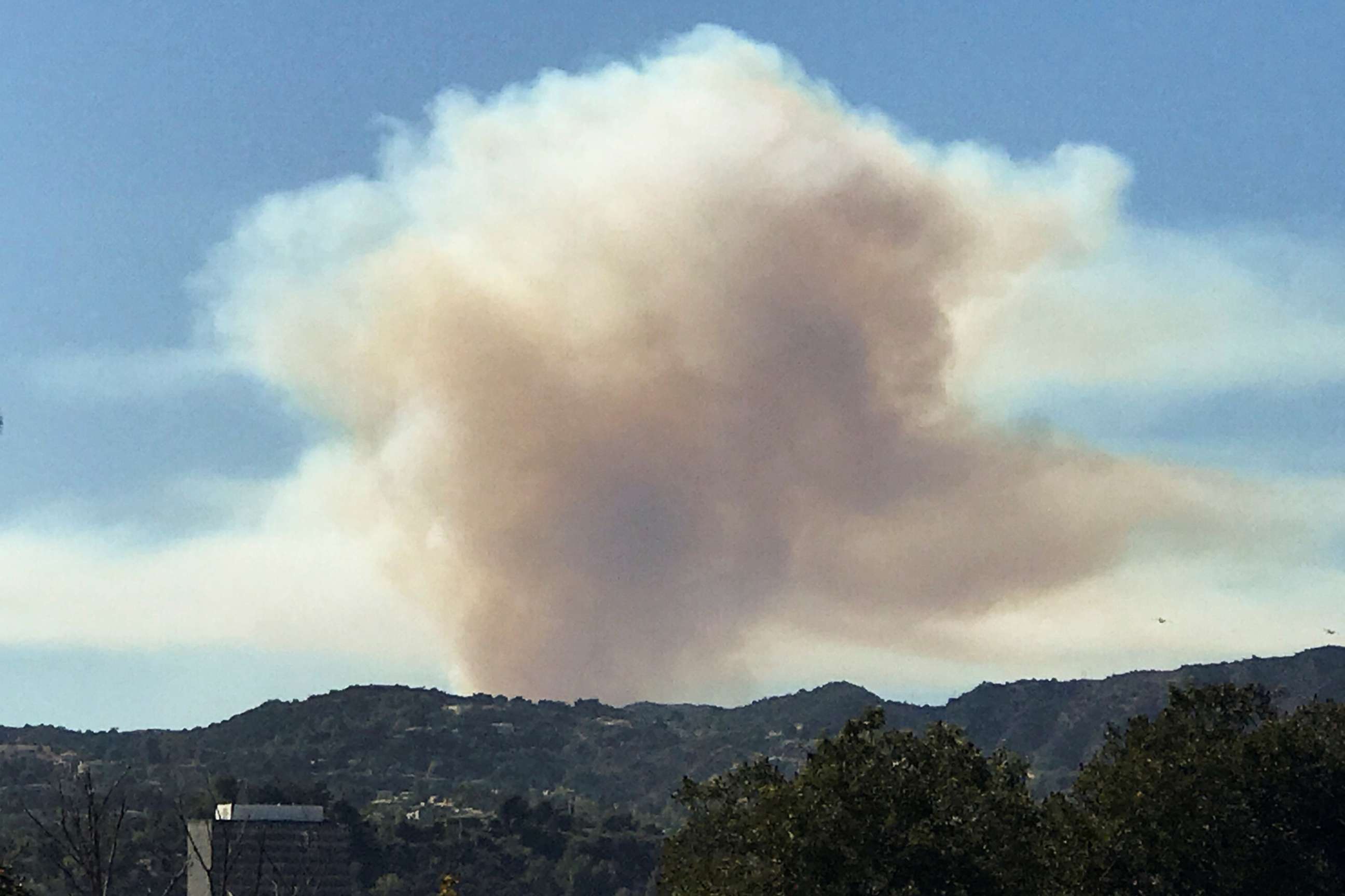 PHOTO: Smoke can be seen as a wild fire breaks out in the hills of Pacific Palisades in Los Angeles, Oct. 21, 2019.