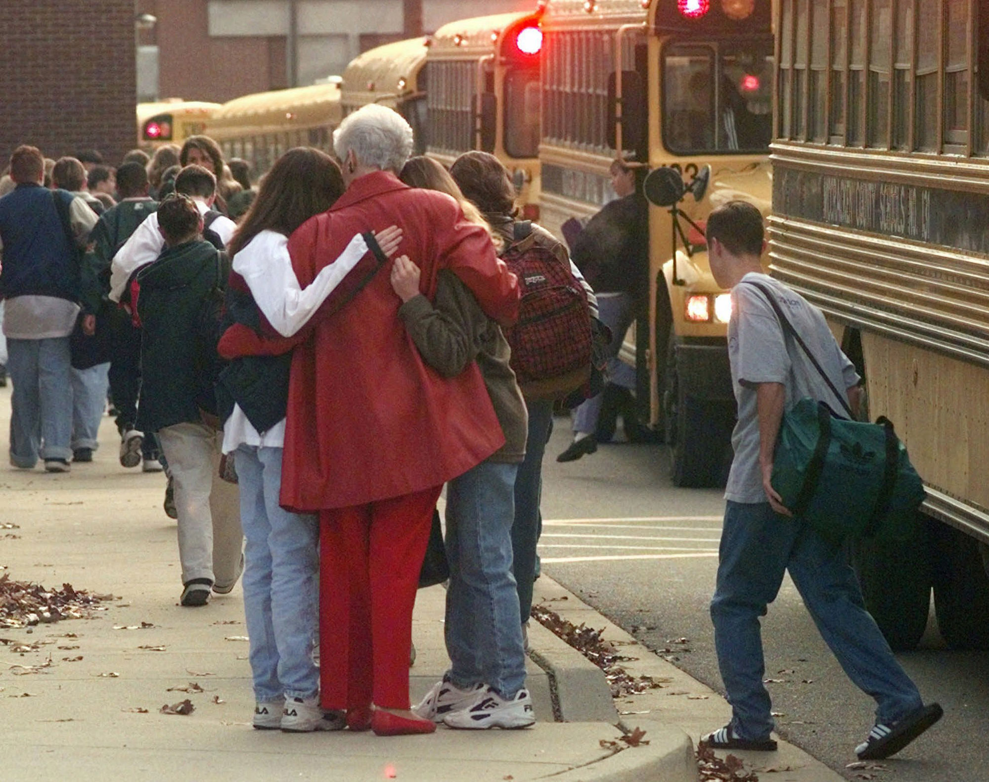 PHOTO: In this Dec. 2, 1997, file photo, students arriving at Heath High School in West Paducah, Ky., embrace an unidentified adult, after student Michael Carneal opened fire at the school the day before, leaving three students dead and five wounded.