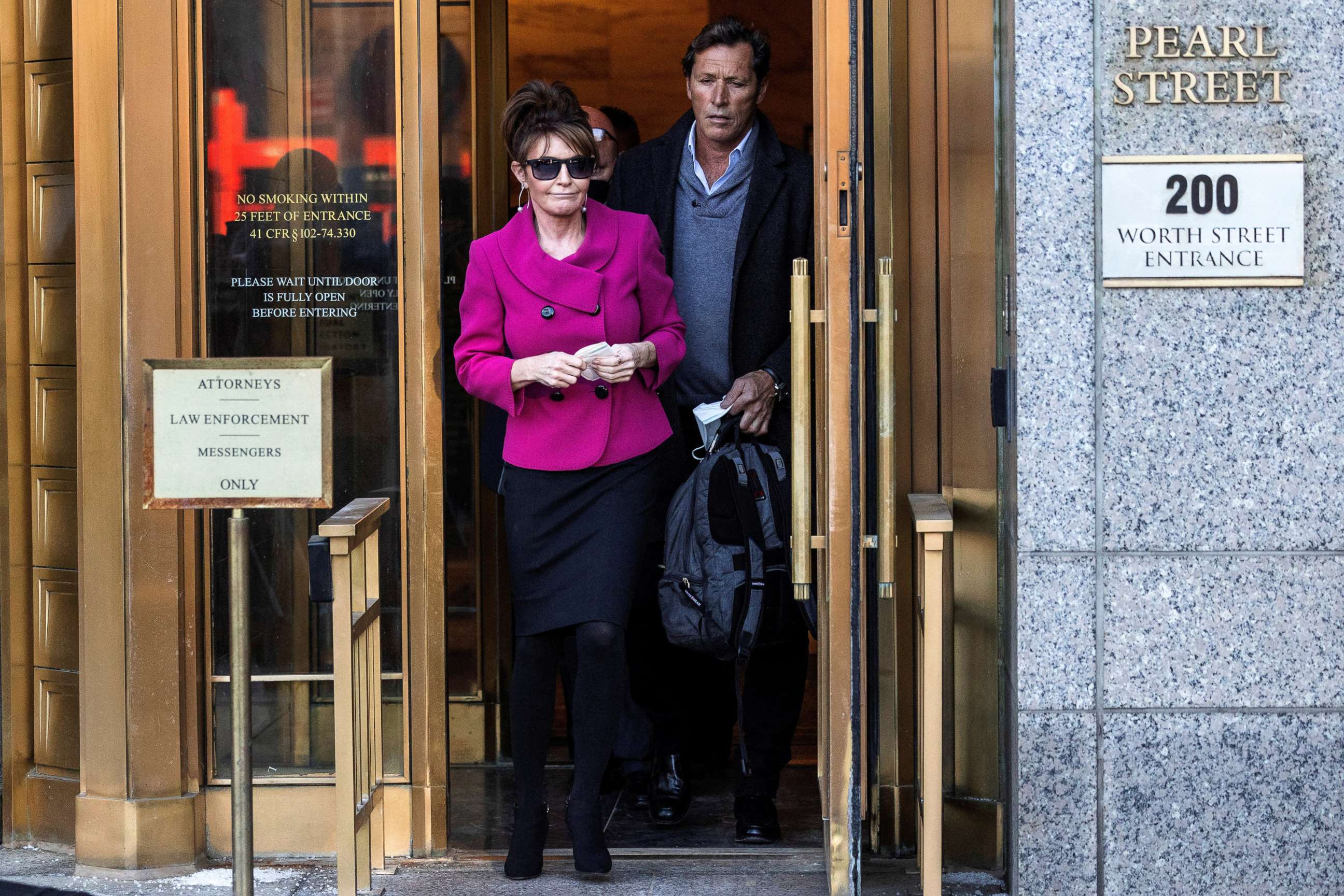 PHOTO: Sarah Palin departs with former NHL hockey player Ron Duguay the United States Courthouse in New York City during her defamation lawsuit against the New York Times, Feb. 9, 2022.