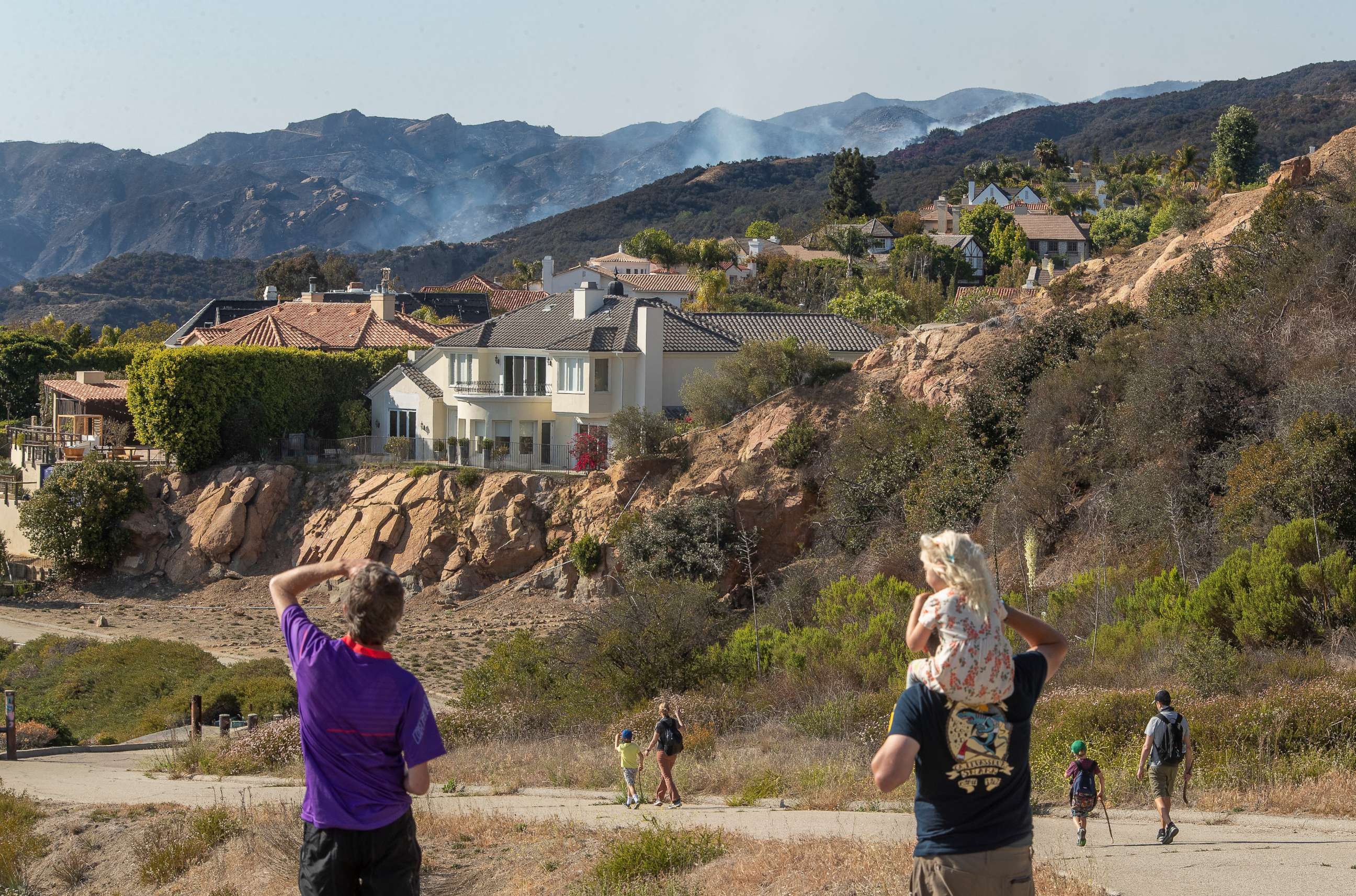 PHOTO: A brush fire burns near homes in the Highlands community of Pacific Palisades in California, as viewed from a fire road, May 17, 2021.